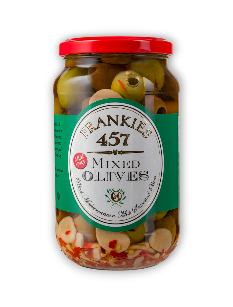 A jar of Frankies 457 mixed olives, showcasing an assortment of olives seasoned with garlic and red chilies, set against a black background.