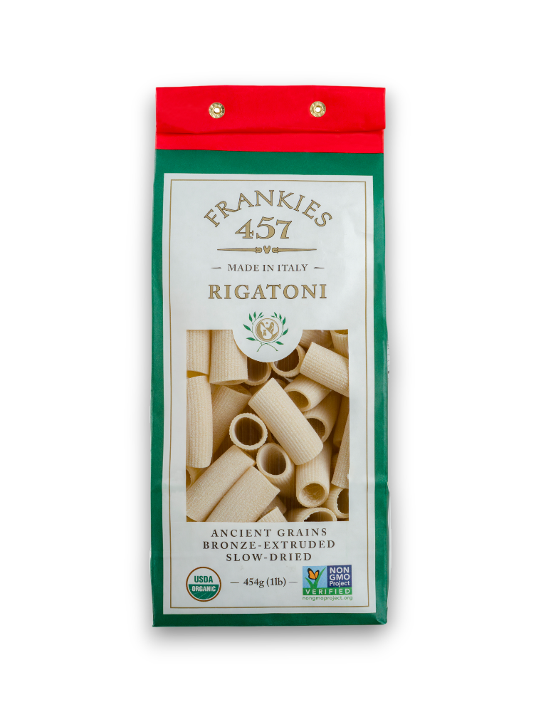 A package of rigatoni pasta from Frankie's 457 brand, showing the pasta through a clear window, with a green and red design on the package.