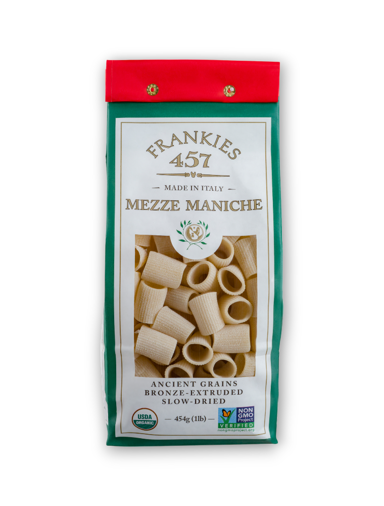 Packaged Mezze Maniche pasta in a white and red bag labeled "Frankies 457." Features cylindrical pasta and certifications like "USDA Organic" and "Non-GMO."