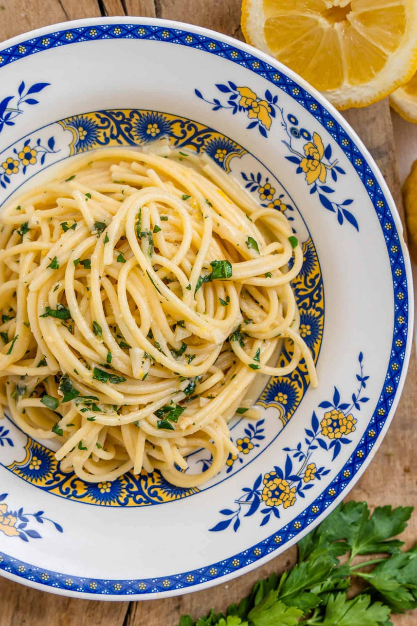 Spaghetti dish with lemon and parsley on a decorative plate